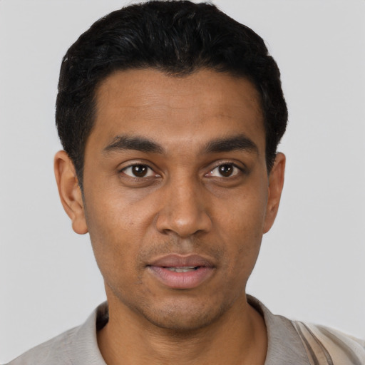 Joyful latino young-adult male with short  black hair and brown eyes