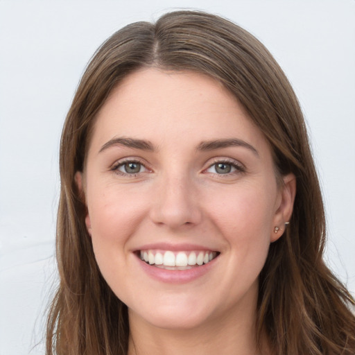 Joyful white young-adult female with long  brown hair and grey eyes