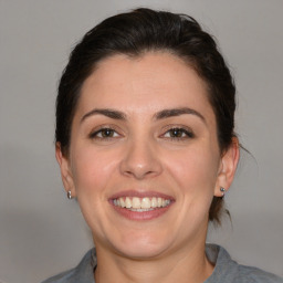 Joyful white young-adult female with medium  brown hair and brown eyes