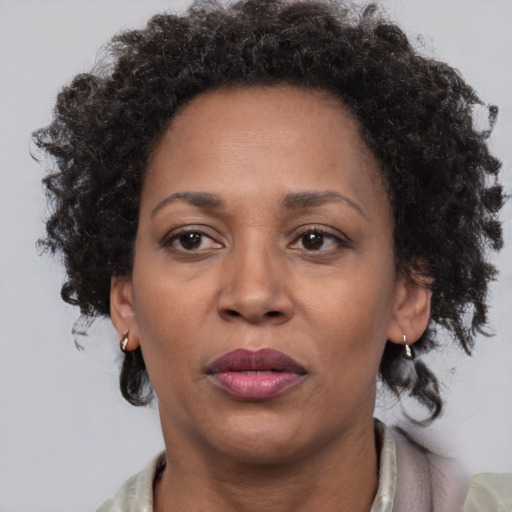 Neutral black adult female with medium  brown hair and brown eyes