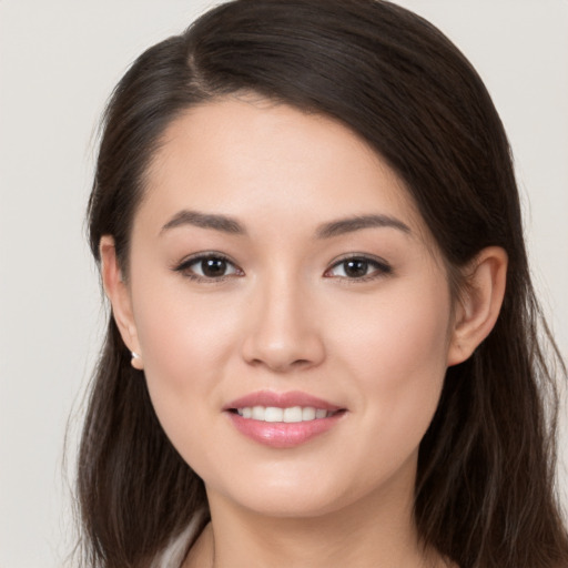 Joyful white young-adult female with long  brown hair and brown eyes