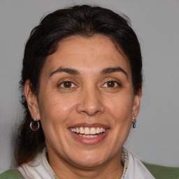 Joyful white adult female with medium  brown hair and brown eyes