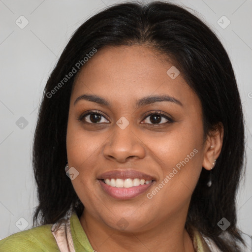 Joyful black young-adult female with long  brown hair and brown eyes