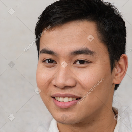 Joyful asian young-adult male with short  brown hair and brown eyes