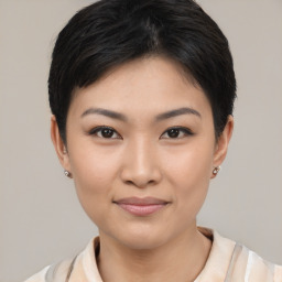 Joyful asian young-adult female with short  black hair and brown eyes