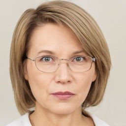 Joyful white adult female with medium  brown hair and blue eyes