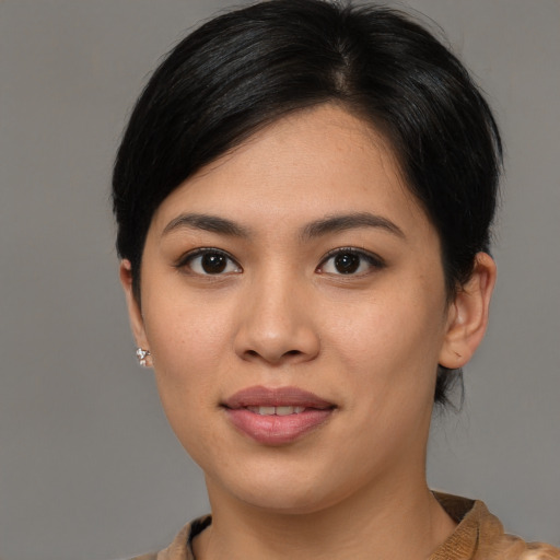 Joyful asian young-adult female with medium  brown hair and brown eyes
