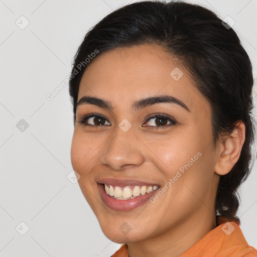 Joyful latino young-adult female with medium  brown hair and brown eyes