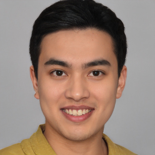 Joyful latino young-adult male with short  black hair and brown eyes