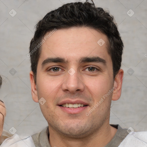 Joyful white young-adult male with short  black hair and brown eyes