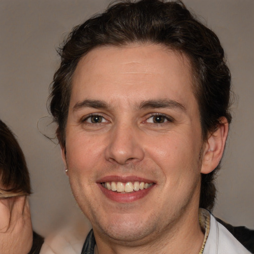 Joyful white adult male with medium  brown hair and brown eyes