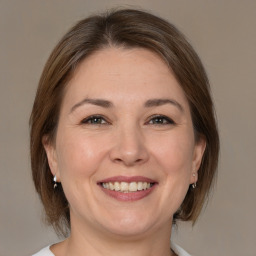 Joyful white adult female with medium  brown hair and brown eyes