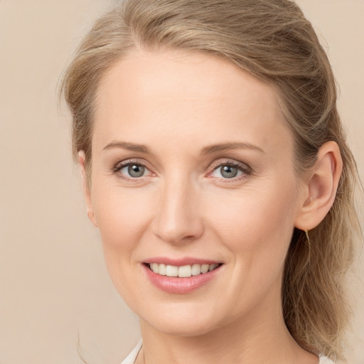 Joyful white young-adult female with long  brown hair and grey eyes