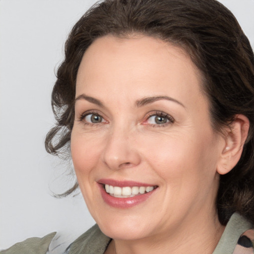 Joyful white adult female with medium  brown hair and brown eyes