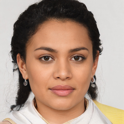 Joyful latino young-adult female with medium  brown hair and brown eyes