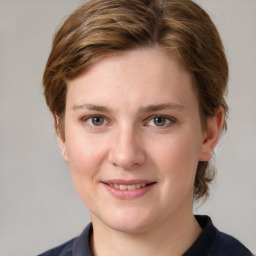 Joyful white young-adult female with medium  brown hair and blue eyes