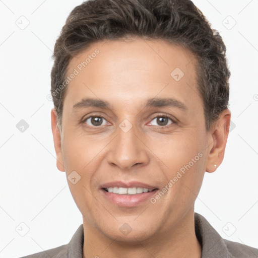 Joyful white adult male with short  brown hair and brown eyes