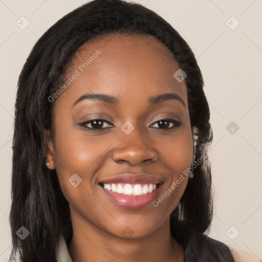 Joyful black young-adult female with long  brown hair and brown eyes