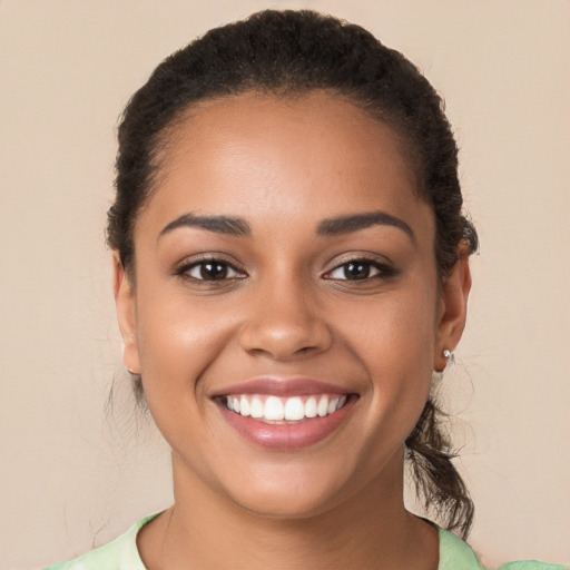 Joyful latino young-adult female with long  brown hair and brown eyes