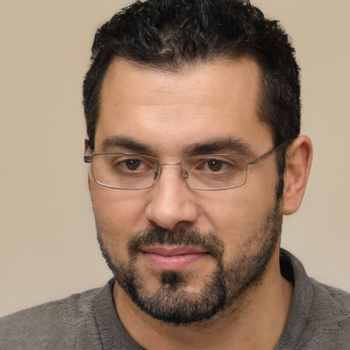 Joyful white adult male with short  black hair and brown eyes