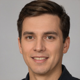 Joyful white young-adult male with short  brown hair and brown eyes