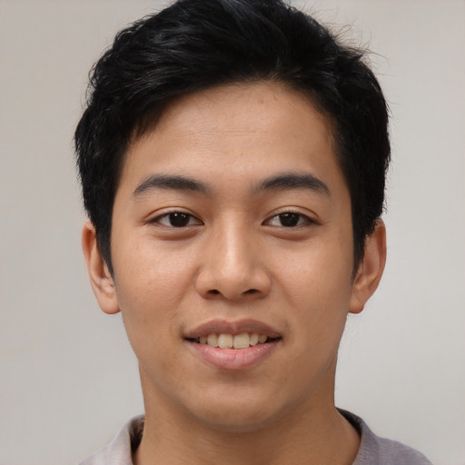 Joyful asian young-adult male with short  black hair and brown eyes