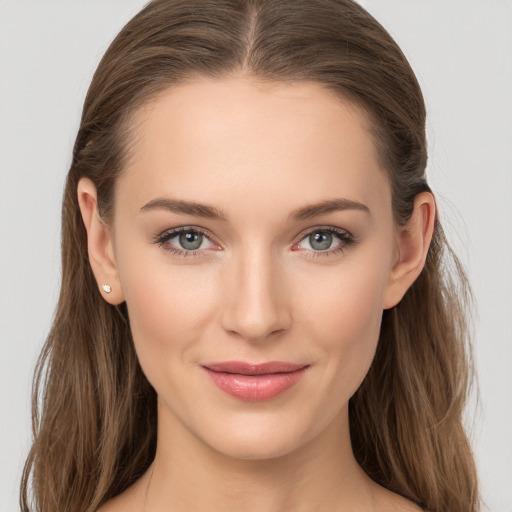 Joyful white young-adult female with long  brown hair and grey eyes