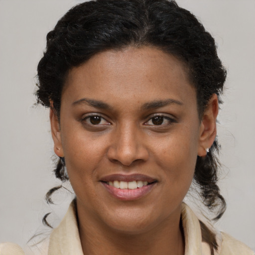 Joyful black young-adult female with short  brown hair and brown eyes