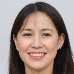 Joyful white adult female with long  brown hair and brown eyes