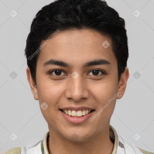 Joyful latino young-adult male with short  brown hair and brown eyes