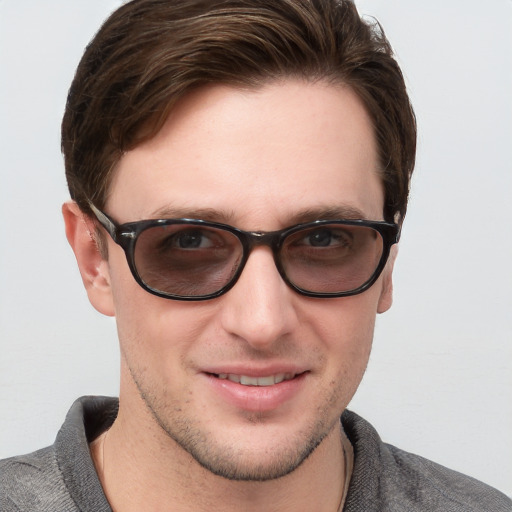 Joyful white young-adult male with short  brown hair and blue eyes