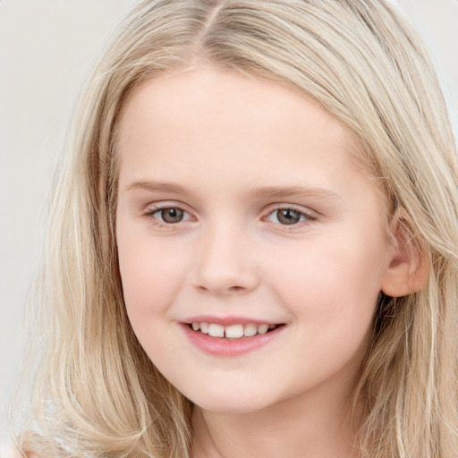 Joyful white child female with long  brown hair and brown eyes