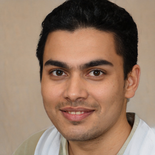 Joyful latino young-adult male with short  brown hair and brown eyes