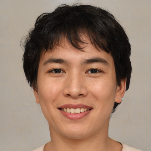 Joyful asian young-adult male with medium  brown hair and brown eyes