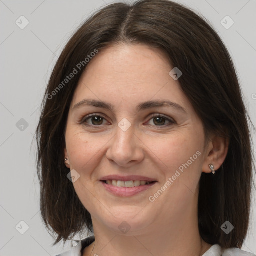 Joyful white adult female with medium  brown hair and brown eyes