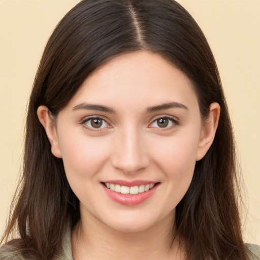 Joyful white young-adult female with long  brown hair and brown eyes