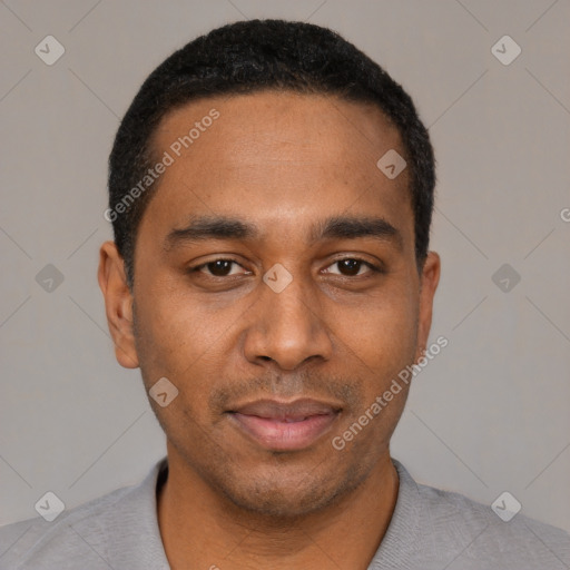 Joyful black young-adult male with short  black hair and brown eyes