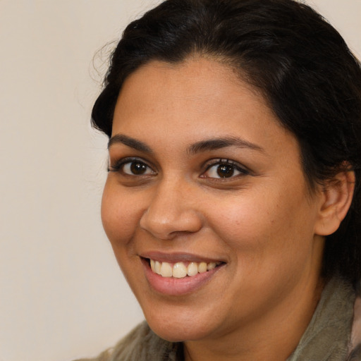 Joyful latino young-adult female with long  brown hair and brown eyes
