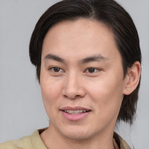 Joyful white young-adult male with medium  brown hair and brown eyes