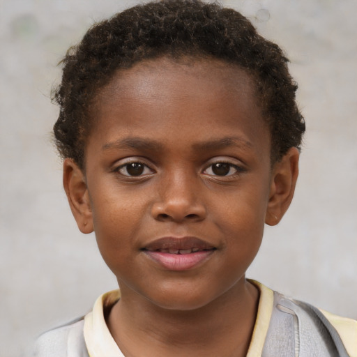 Joyful black child male with short  brown hair and brown eyes