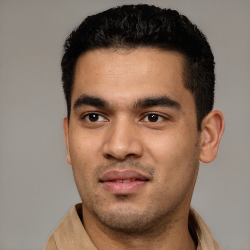 Joyful white young-adult male with short  black hair and brown eyes
