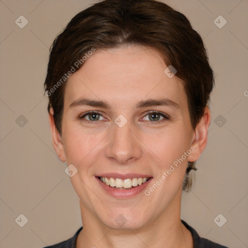 Joyful white young-adult female with short  brown hair and grey eyes