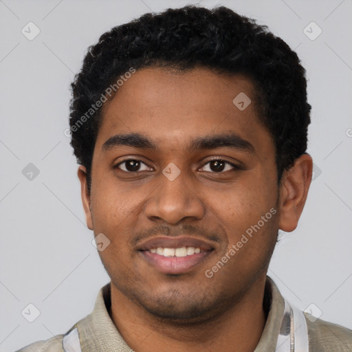 Joyful black young-adult male with short  black hair and brown eyes