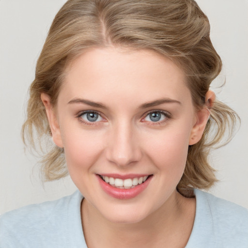 Joyful white young-adult female with medium  brown hair and blue eyes