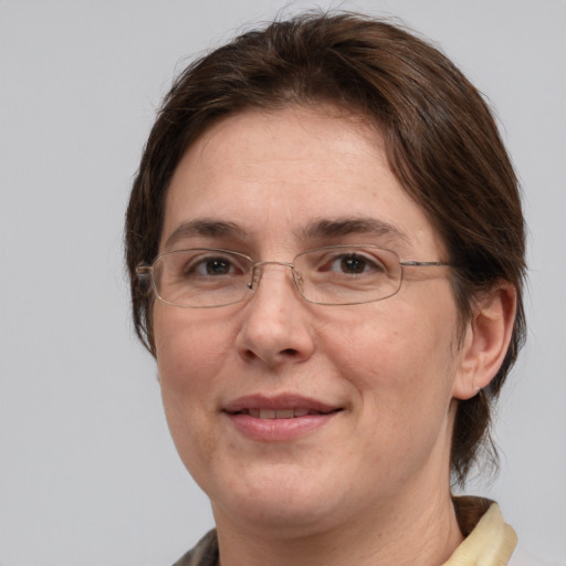 Joyful white adult female with medium  brown hair and grey eyes