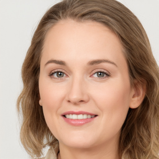 Joyful white young-adult female with long  brown hair and green eyes