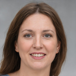 Joyful white adult female with medium  brown hair and grey eyes