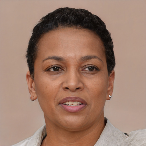 Joyful latino adult female with short  brown hair and brown eyes