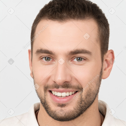 Joyful white young-adult male with short  brown hair and brown eyes