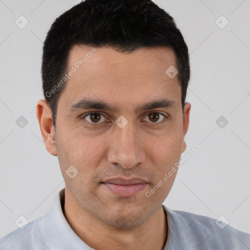 Joyful white young-adult male with short  black hair and brown eyes